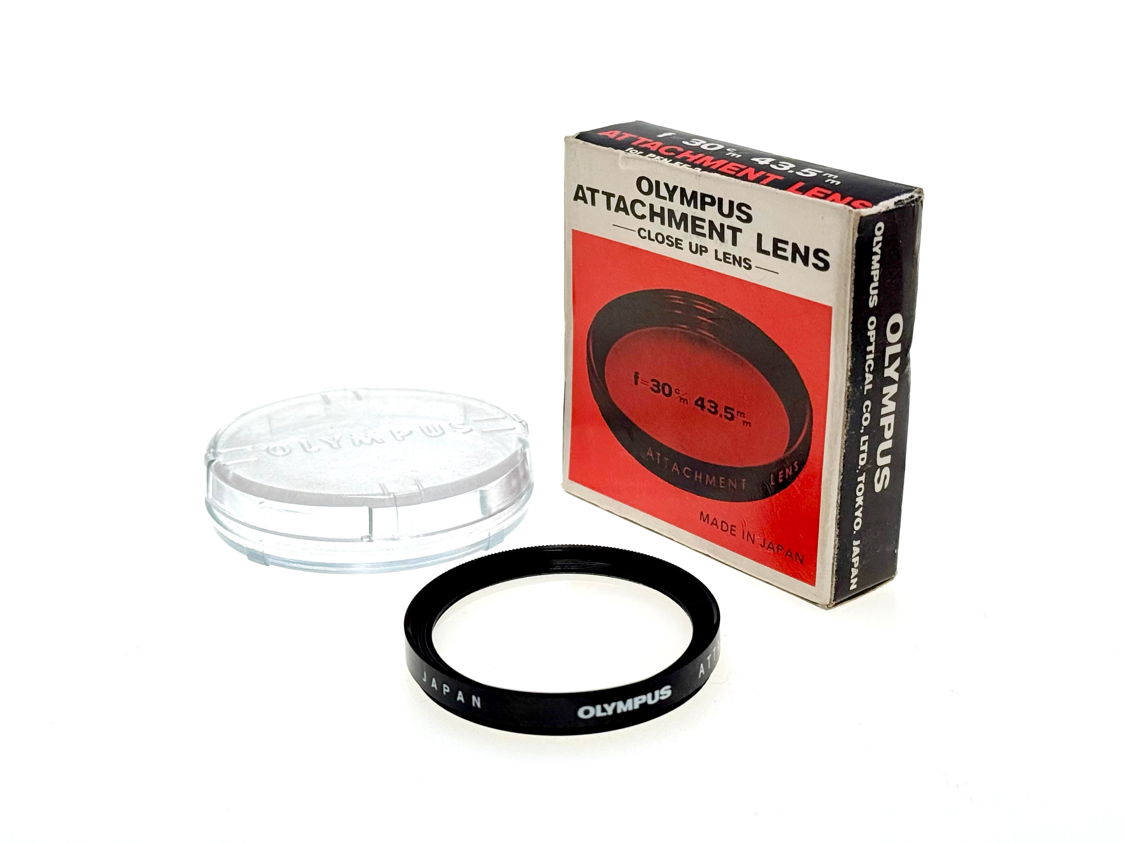 Olympus close-up lens with packaging on a white background