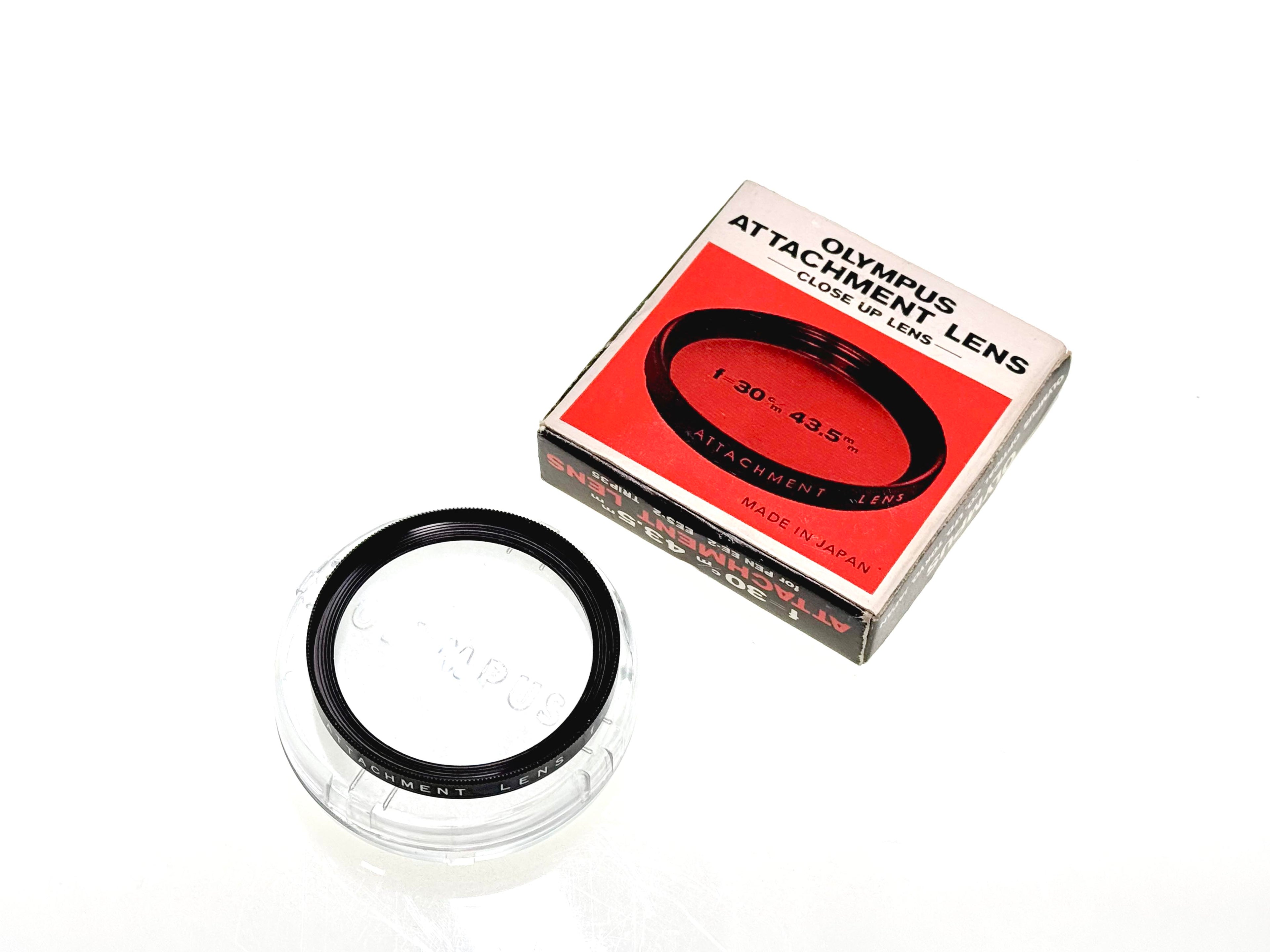 Olympus attachment lens with packaging on a white background for film cameras