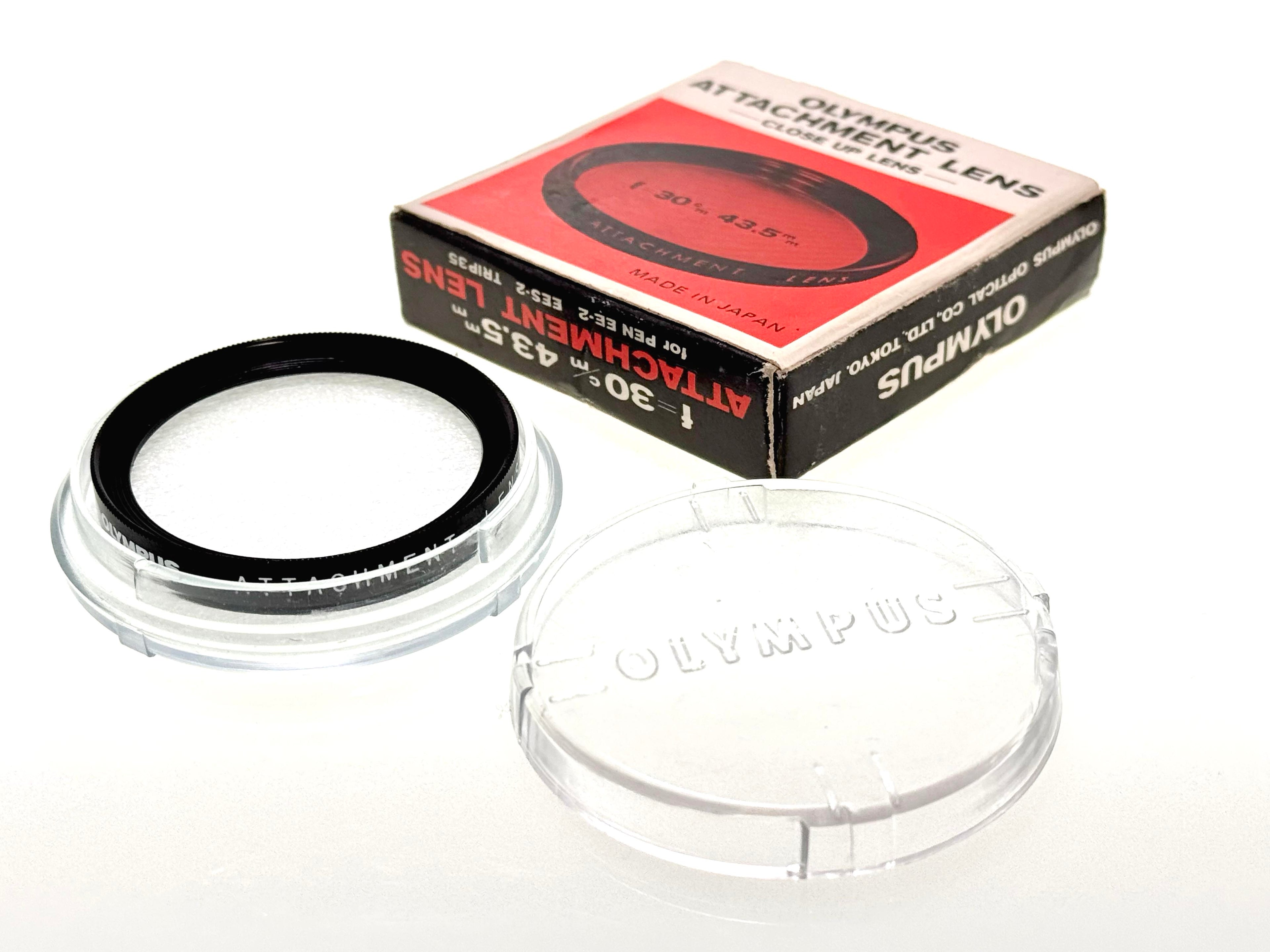 Olympus film camera attachment lens with packaging on a white background