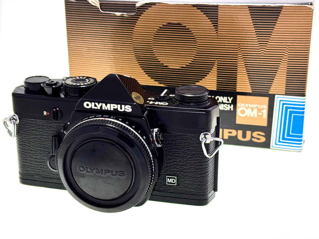 Black Olympus camera with branded box in the background