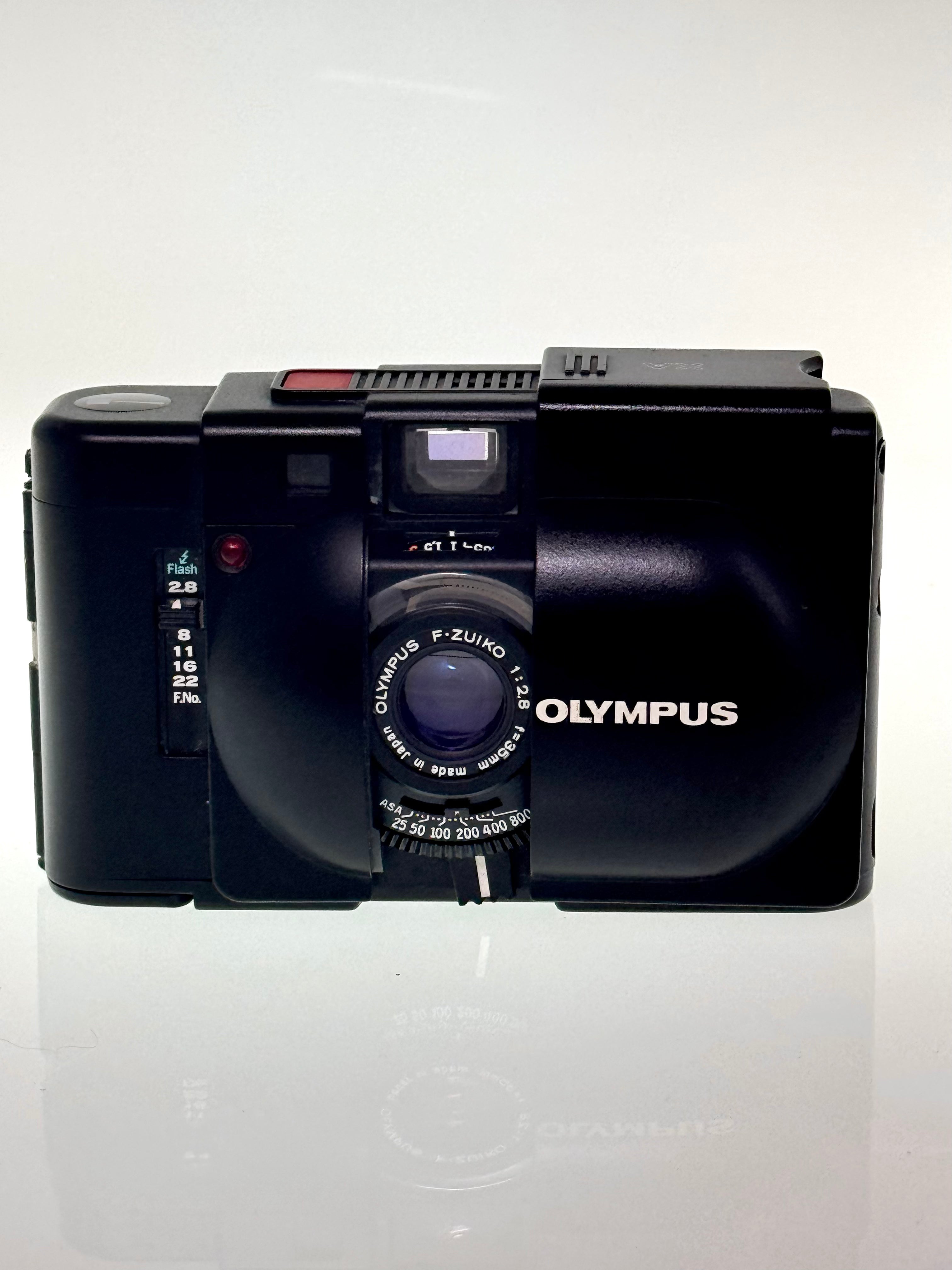 Compact Olympus XA film camera on a white background